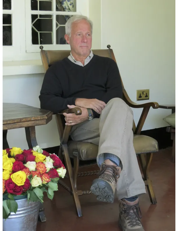 John sitting in a wooden chair