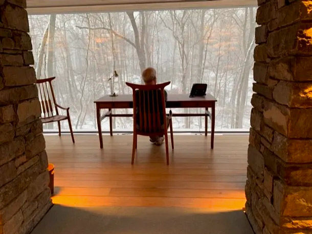 John Barr sitting at his desk in his studio