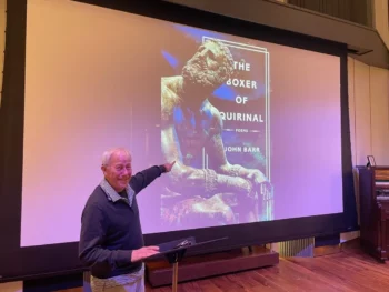 John pointing to a projection of his new book! (Photo taken by a family member.)